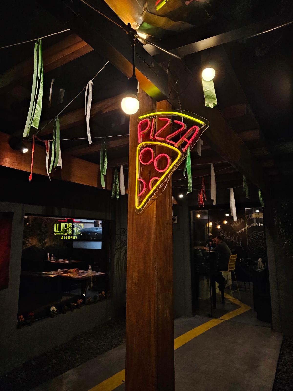 Bar de madeira com neon em formato de pizza